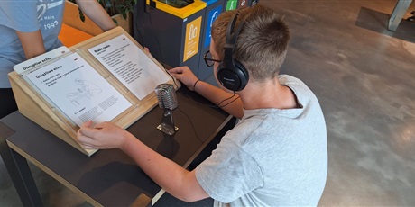 Powiększ grafikę: Uczeń przy stanowisku wystawowym.