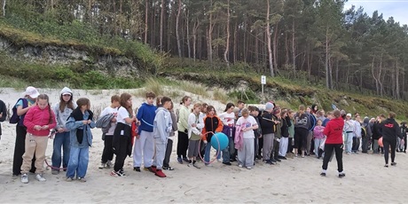 Powiększ grafikę: Zbiórka uczestników na plaży.